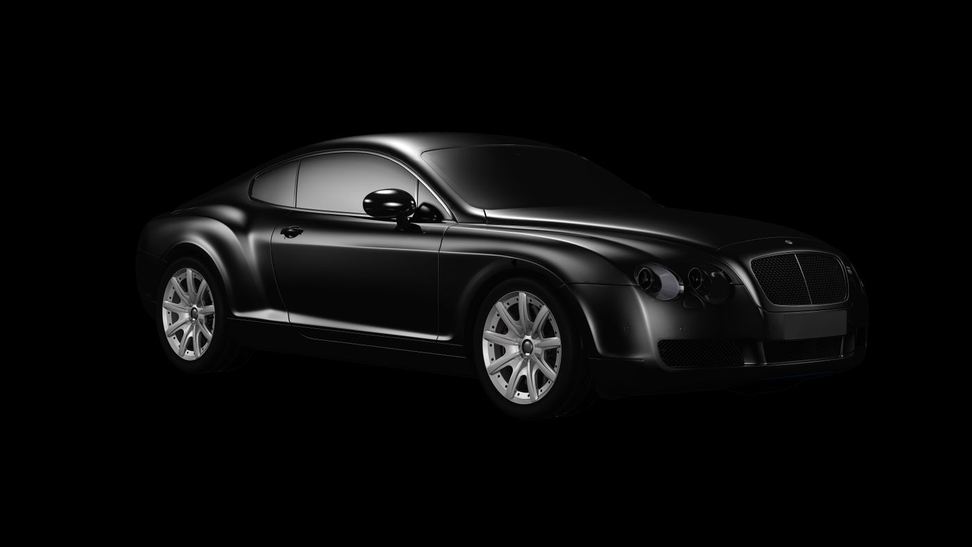 A black luxury sedan lit against a dark studio background