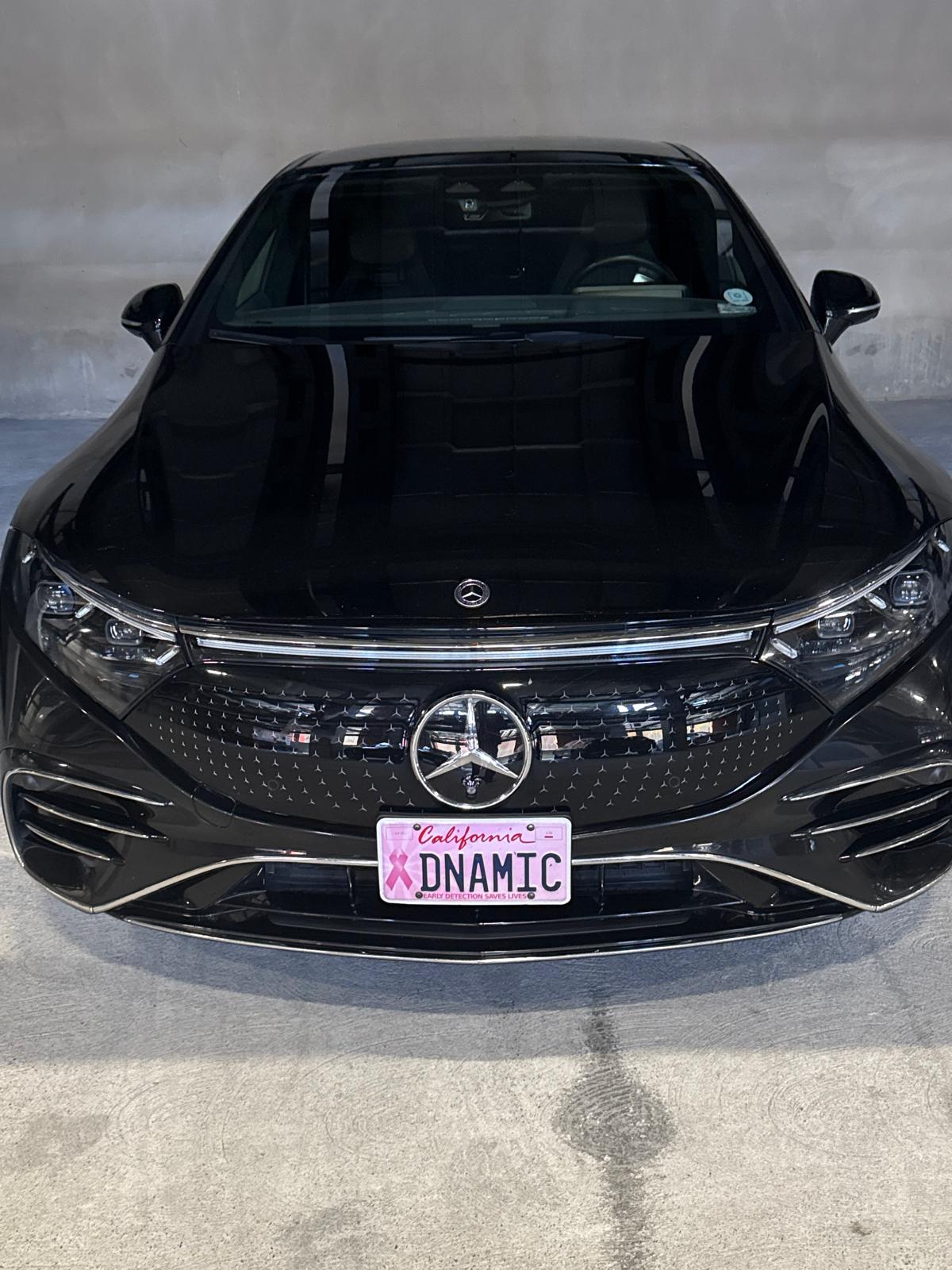 Head-on view of Jet Car Limo's black Mercedes-Benz EQS in the garage