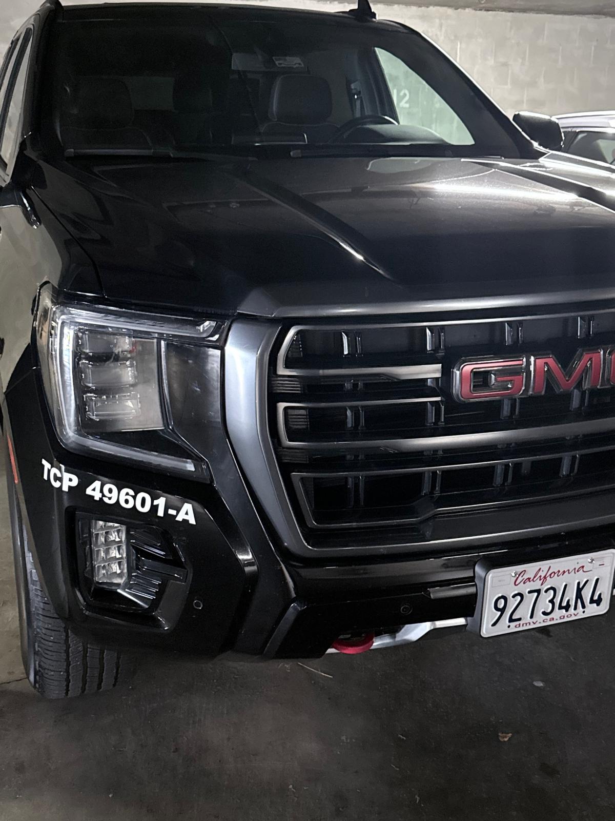 Close-up of the TCP 49601-A licence marking on the fender of Jet Car Limo's GMC Yukon XL